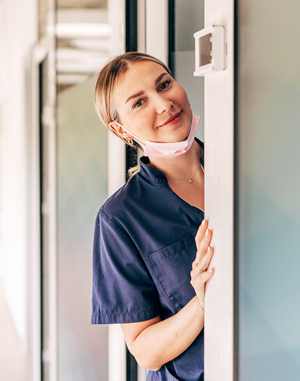 A dental hygienist flashes a big smile at Smile Clinique