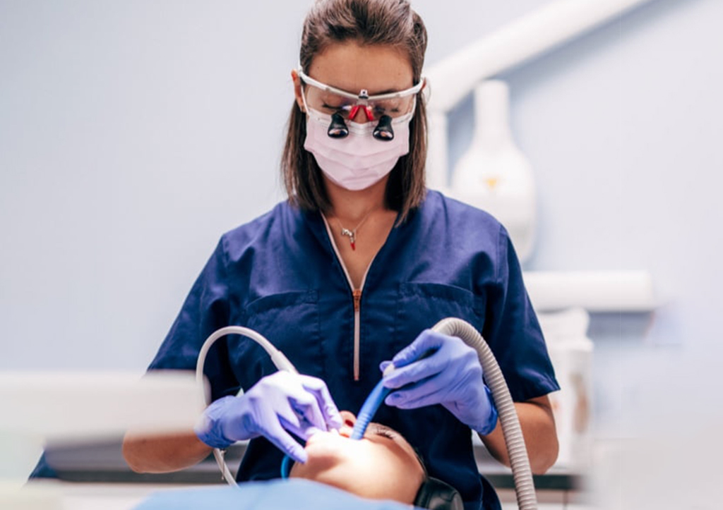 A dental hygienist provides dental hygiene care to a patient